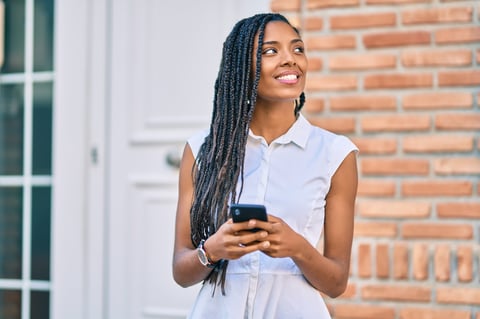 Young woman smiling with phone