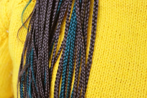 Dreadlocks in yellow sweater